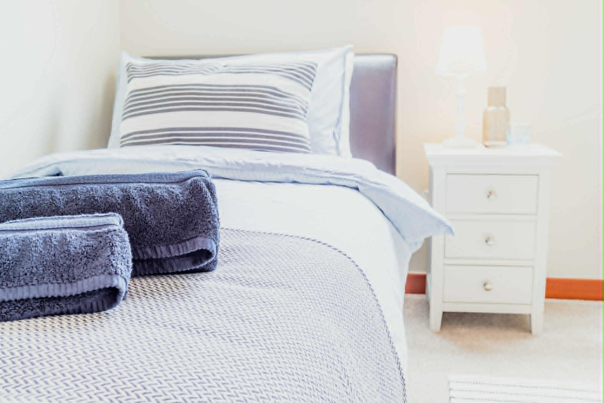 Single bedroom with fresh towels