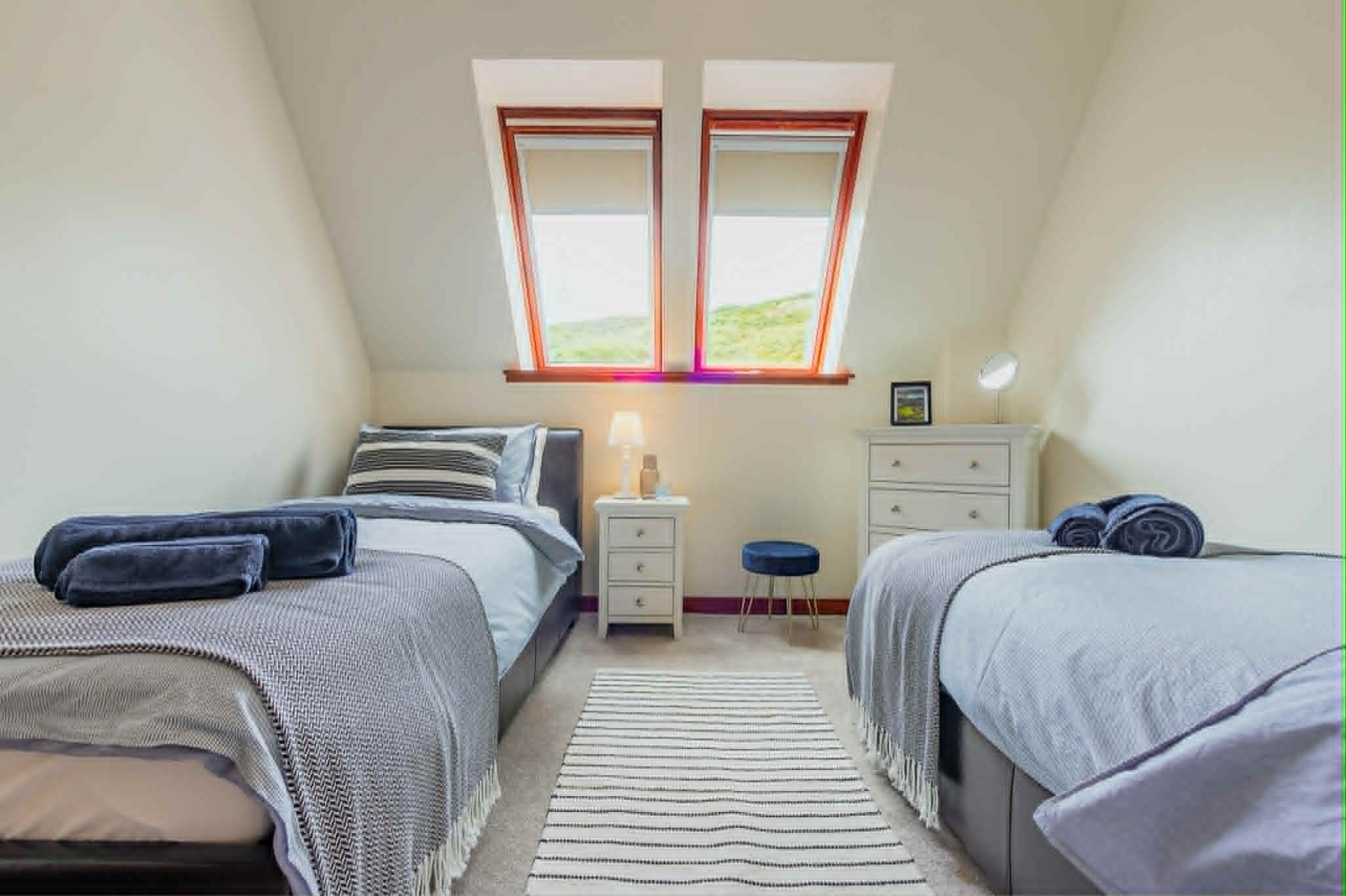 Bright twin bedroom with fresh linen and towels
